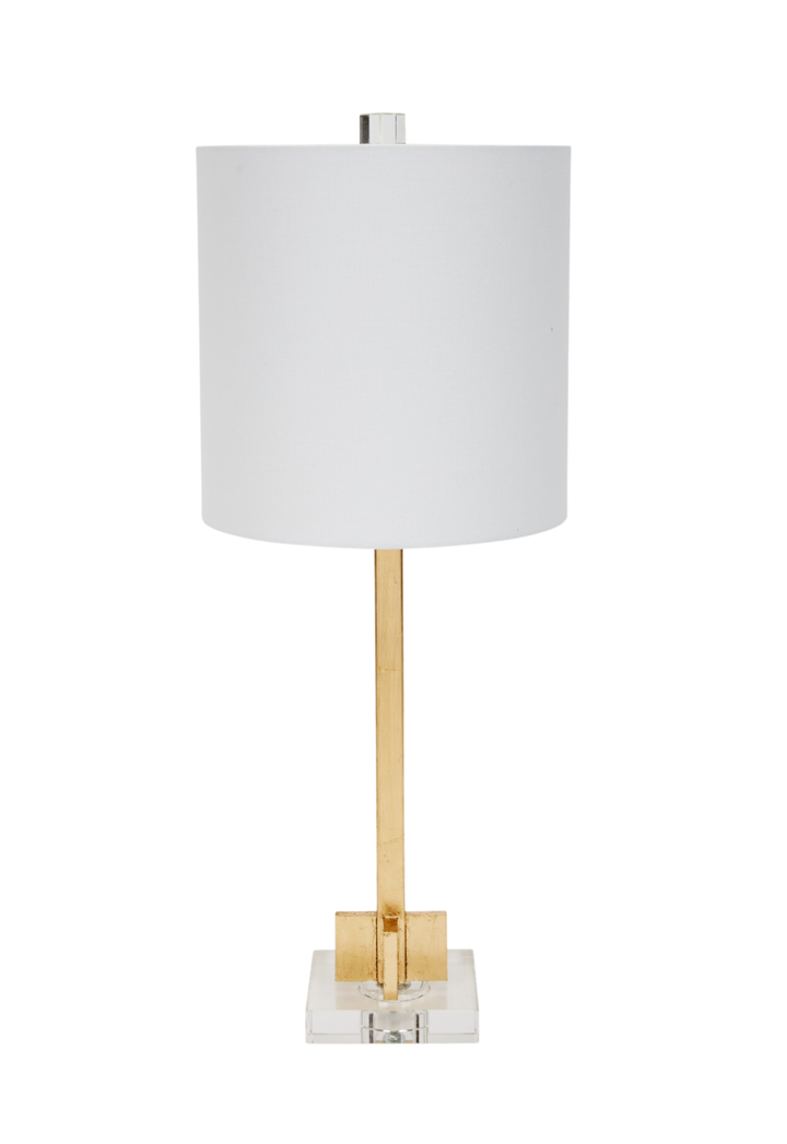 Modern table lamp with white drum shade, slim gold metal base, and clear acrylic square platform, minimalist luxury home lighting.