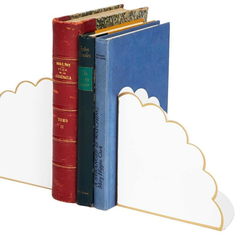 White and gold scalloped bookends holding stacked books