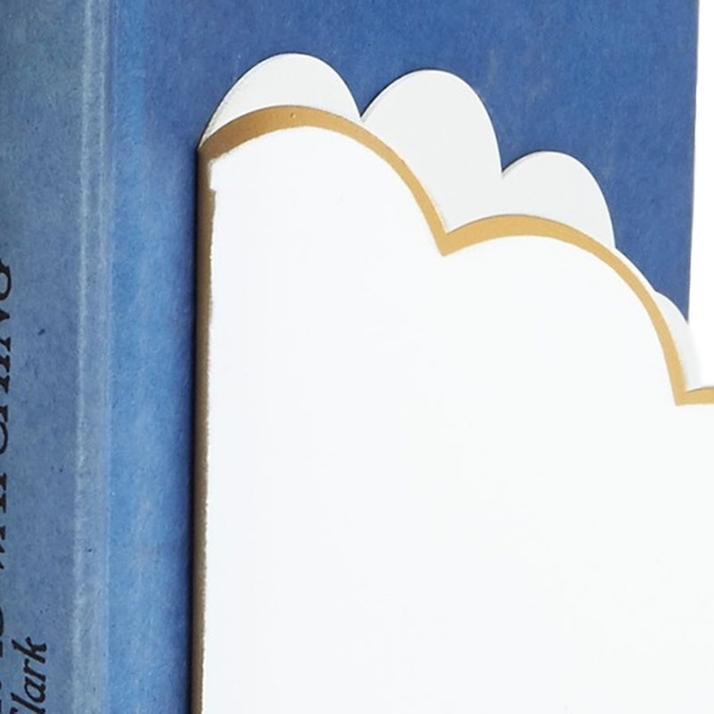 White scalloped bookend with gold outline, close-up