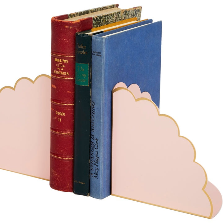 Blush and gold scalloped cloud bookends holding stacked books