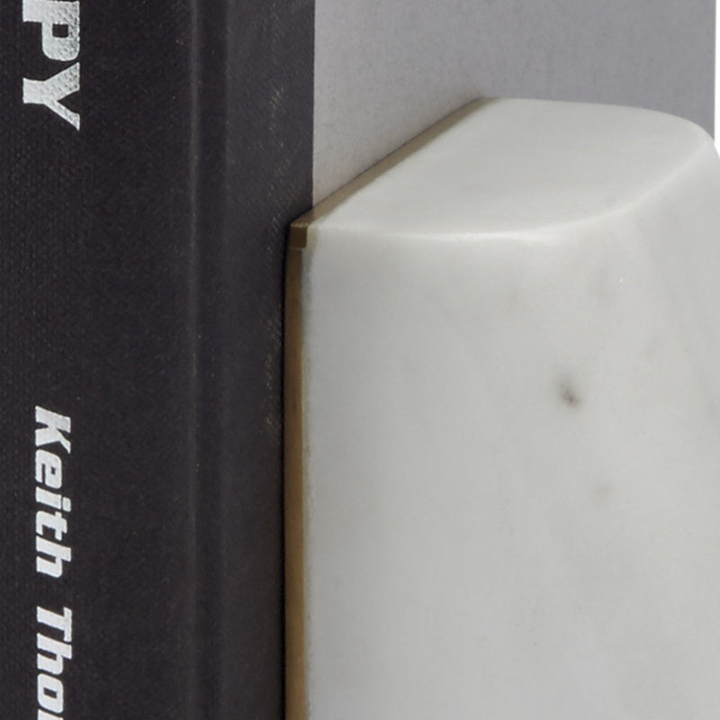 White marble bookend corner with brass inlay, angled edge close-up