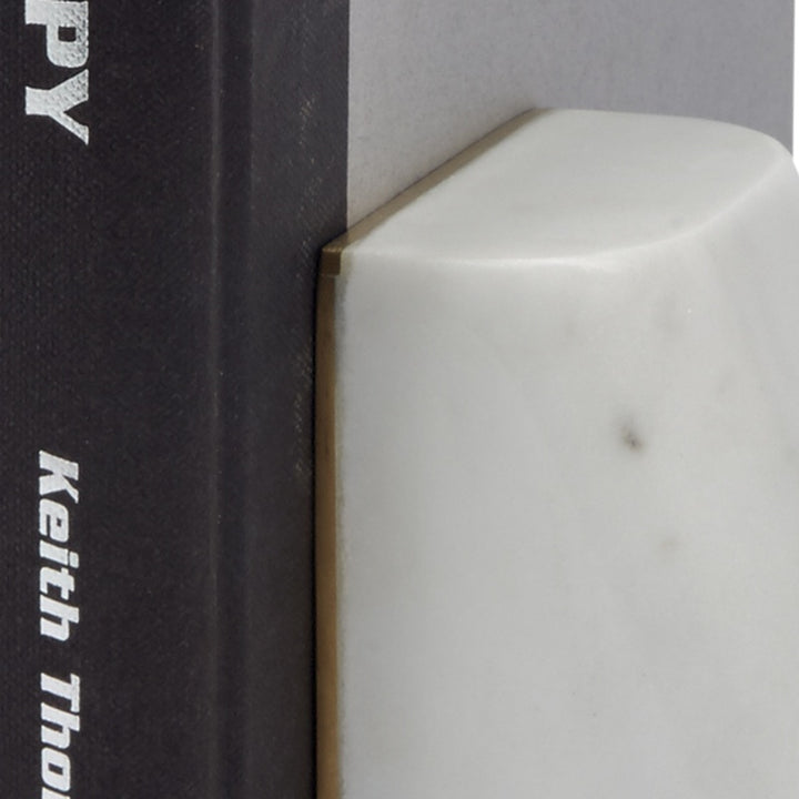 White marble bookend corner with brass inlay, angled edge close-up