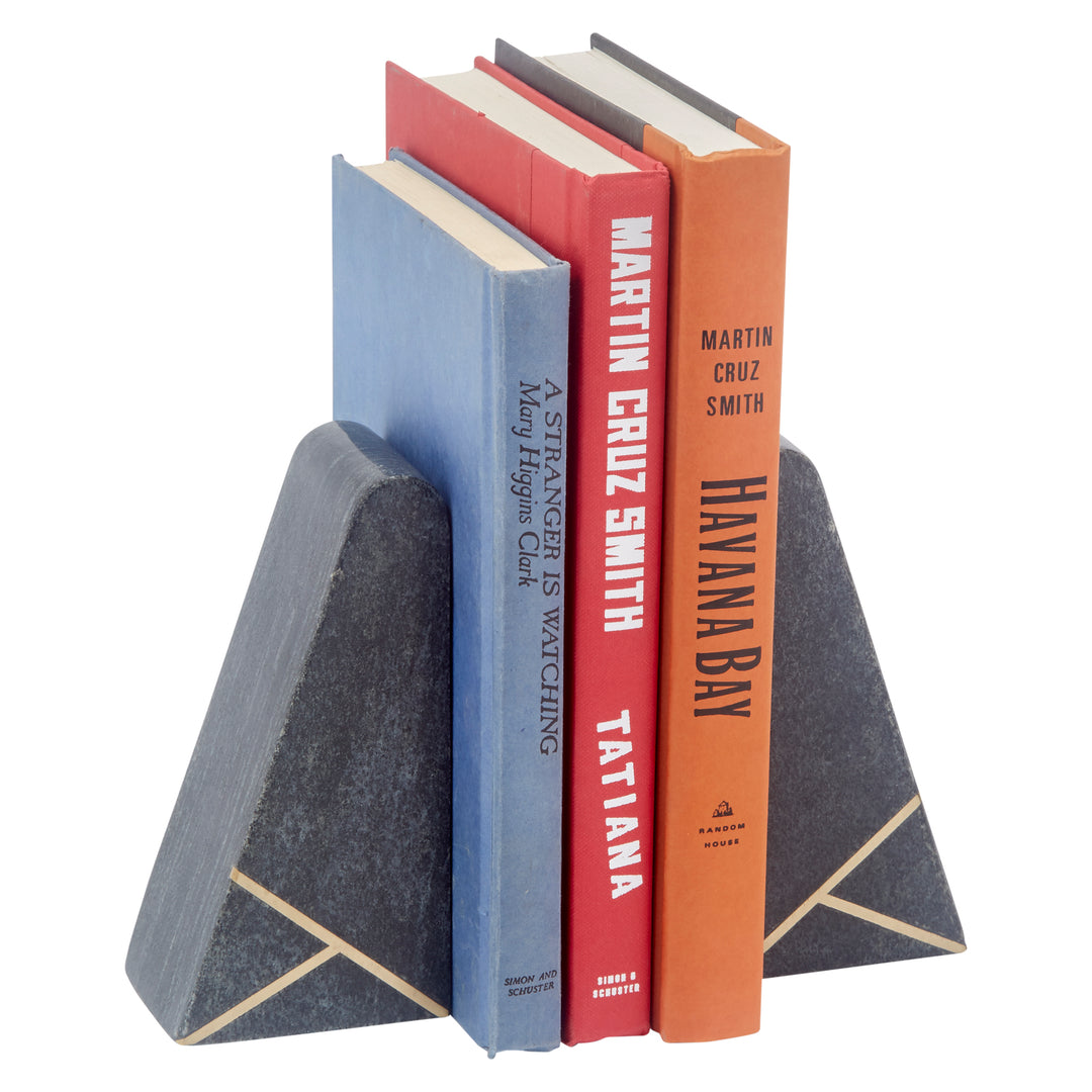 Angled black marble bookends with brass inlay, supporting books