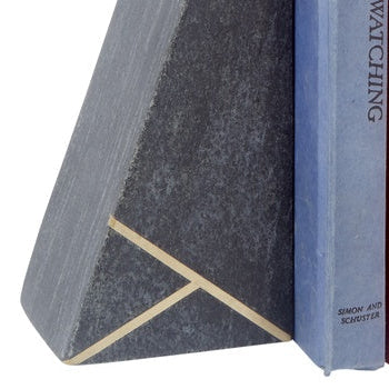 Angled dark stone bookend with gold inlay lines, close-up