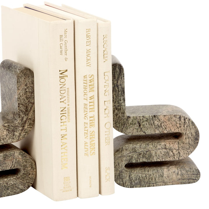 Curved stone-look bookends gripping book spines, angled close-up
