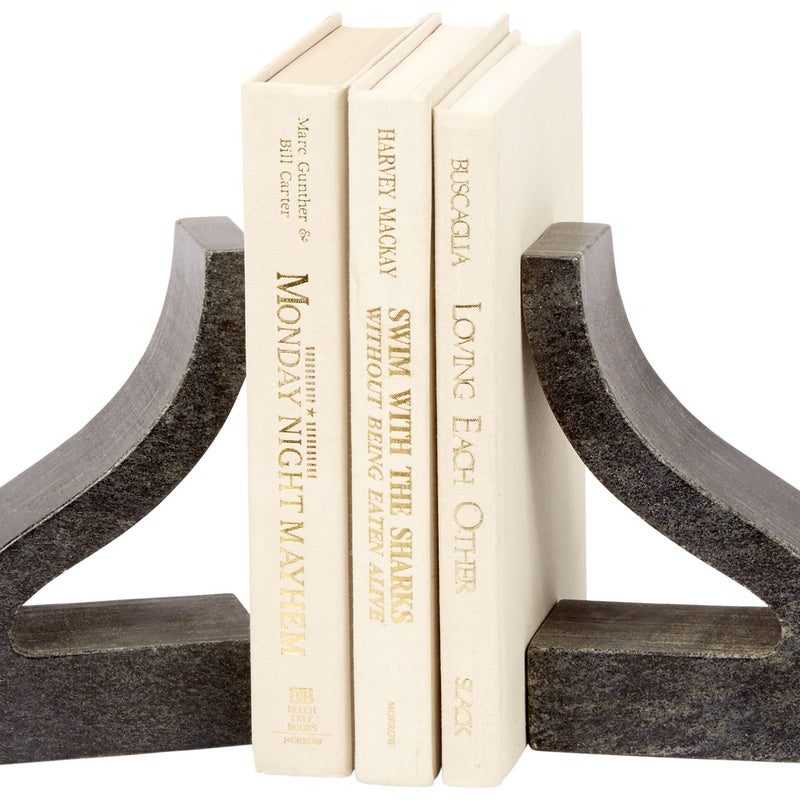 Black marble ornate bookends with wide curved base, holding cream hardcover books