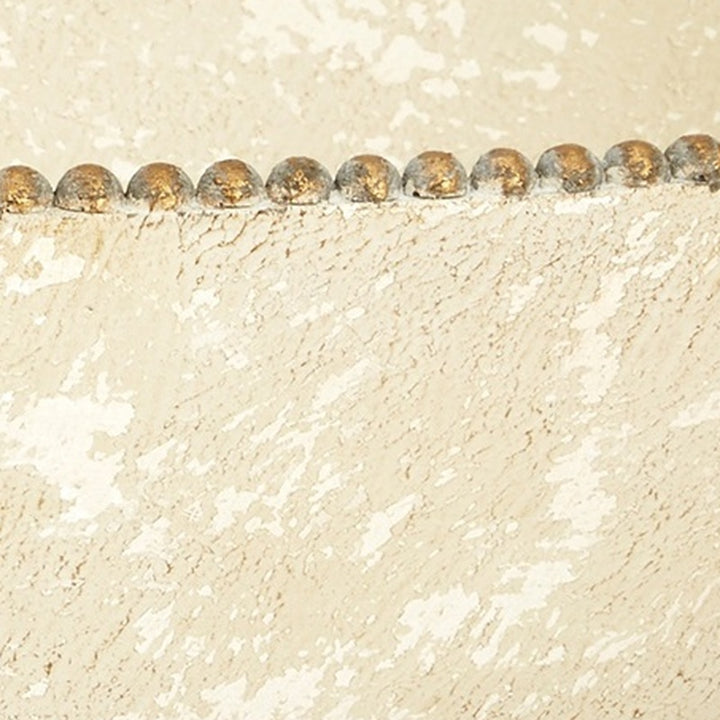 Close-up of beige speckled bowl edge with aged gold bead line