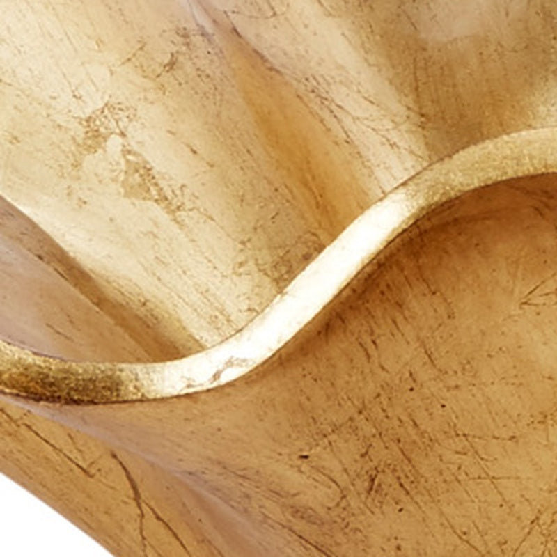 Gold leaf interior of decorative bowl with smooth curved wavy edge