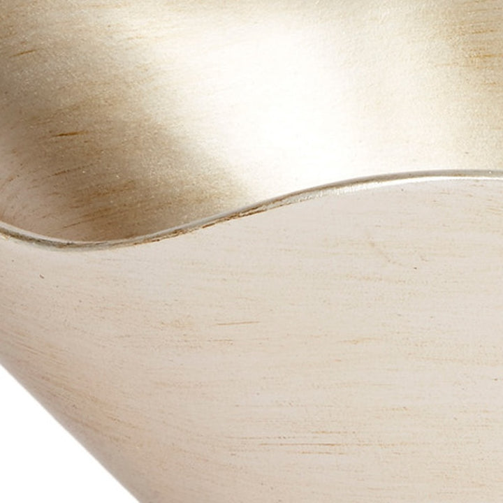 Close-up of brushed champagne silver bowl interior and curved edge