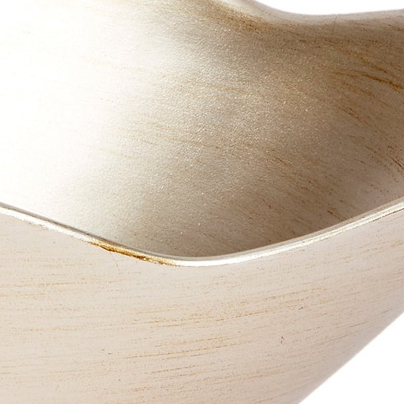 Close-up of champagne silver bowl rim and brushed metallic surface