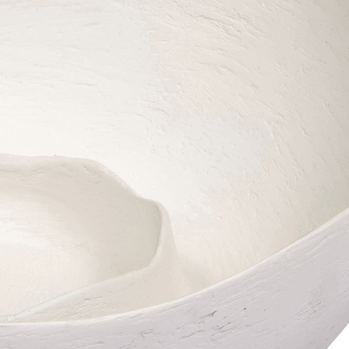 White decorative bowl interior detail with sculpted swirl pattern and curved lip