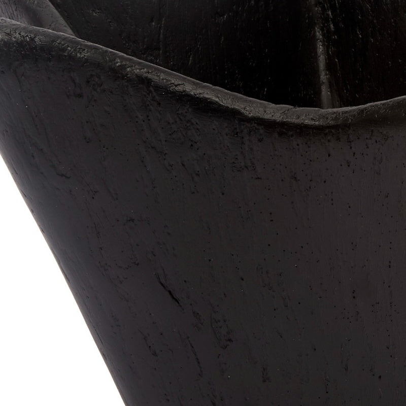 Black decorative bowl close-up, textured gesso surface and curved sculpted side