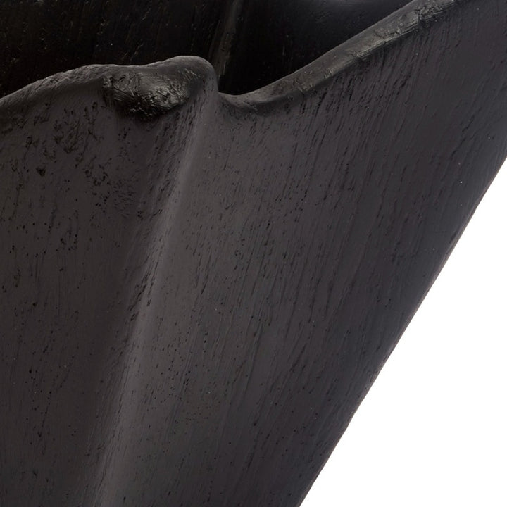 Black decorative bowl rim close-up, wavy sculpted edge and textured gesso finish