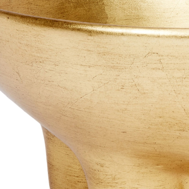 Close-up of gold leaf decorative bowl surface with subtle marks and smooth rim.