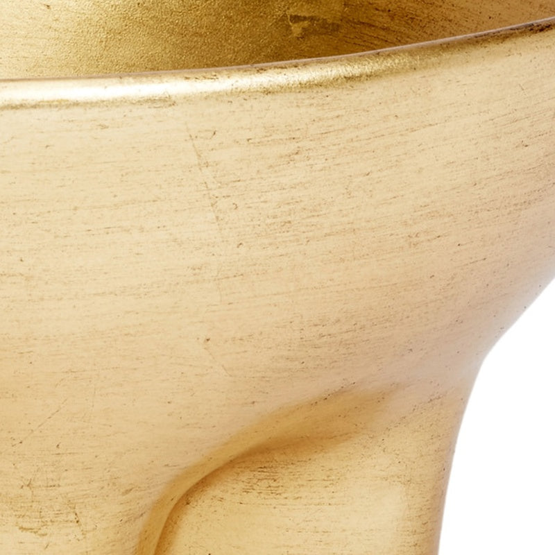 Close-up of gold decorative bowl interior curve with glossy leaf finish.