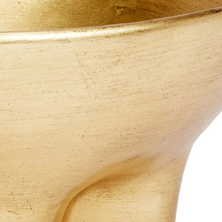 Close-up of gold decorative bowl interior curve with glossy leaf finish.