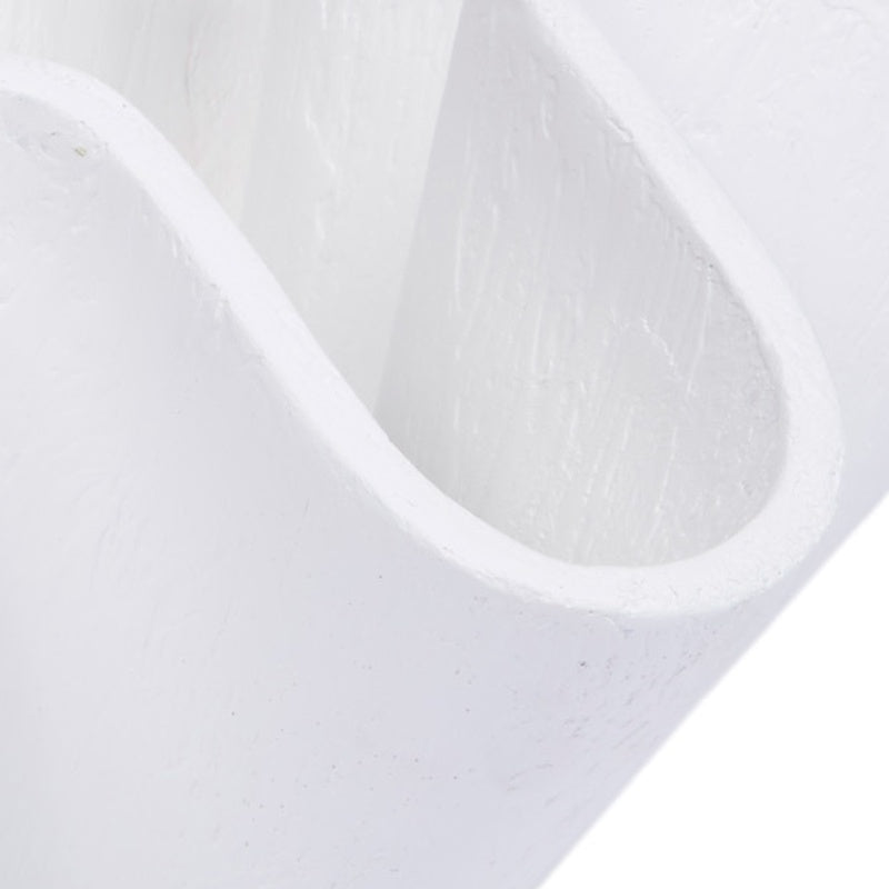 White decorative bowl detail showing curved open channel and textured finish