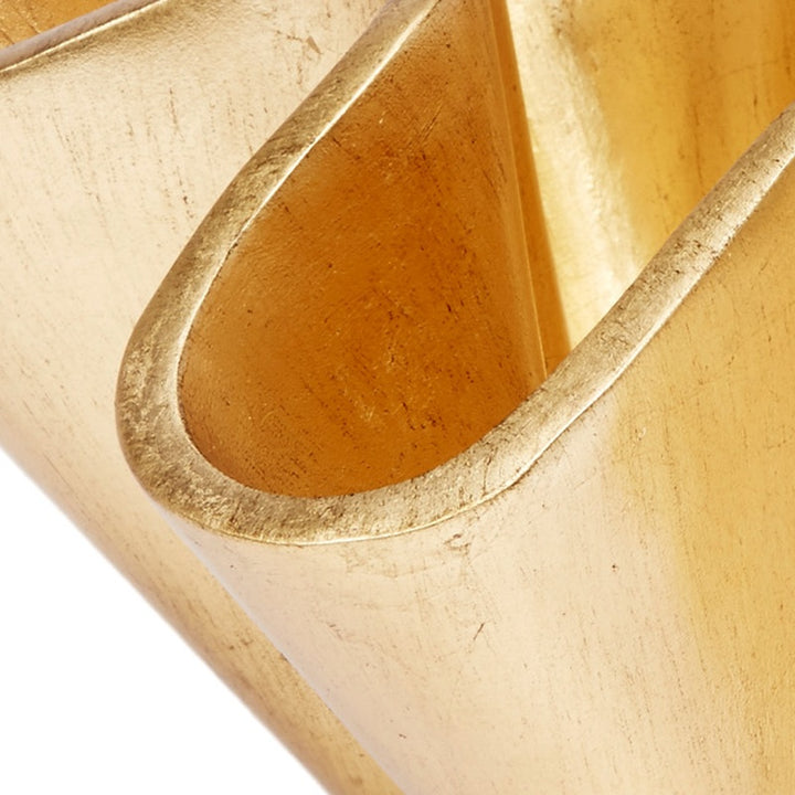 Close-up of gold wave bowl interior with curved cutout edges
