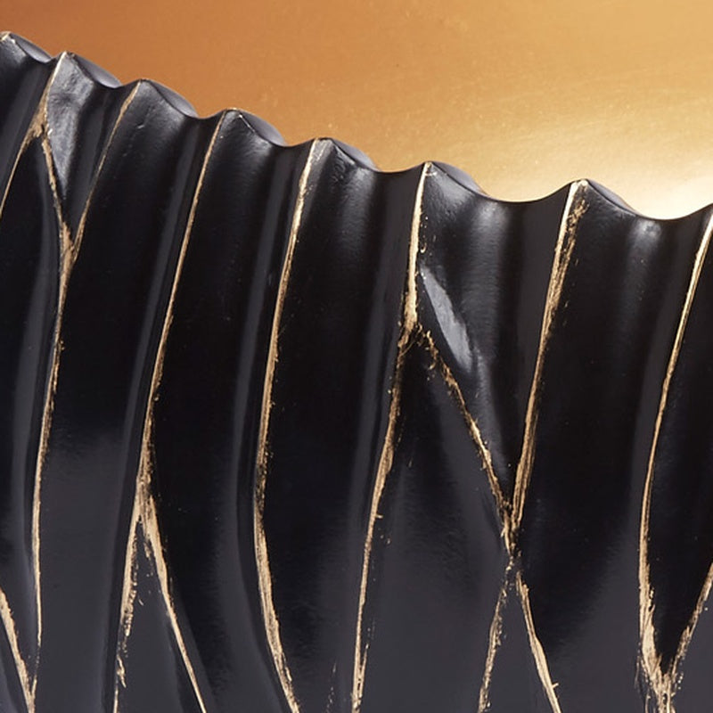 Decorative black bowl with gold accents and scalloped fluted rim detail