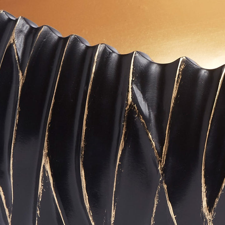 Decorative black bowl with gold accents and scalloped fluted rim detail