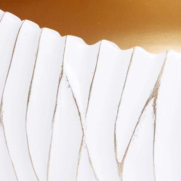 White decorative bowl with scalloped rim and subtle gold accents along vertical ridges