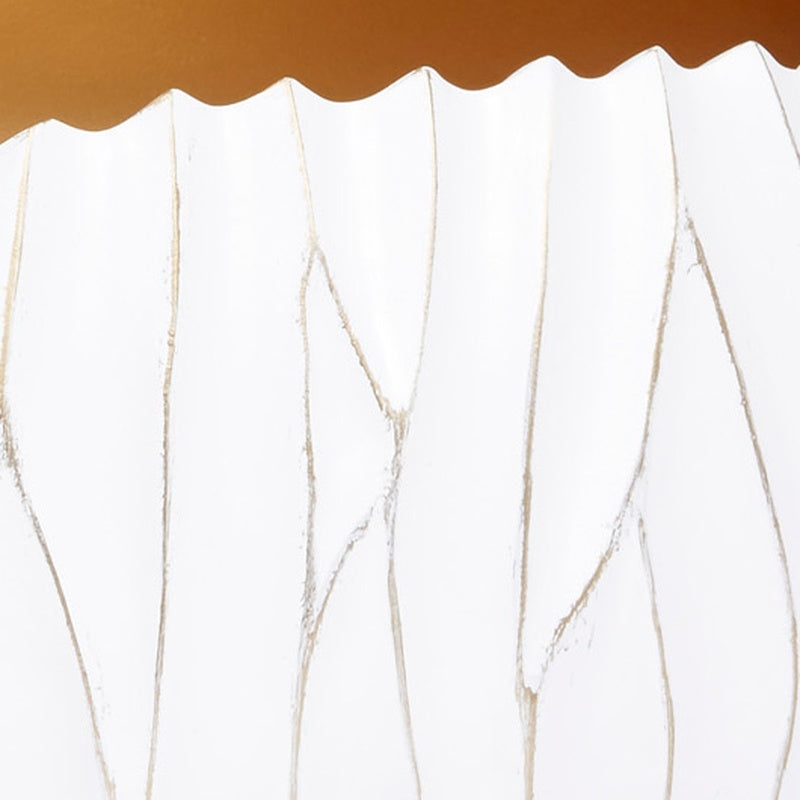 White decorative bowl with scalloped top edge and gold-accented ridged texture