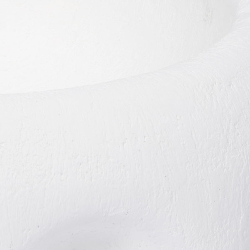 White gesso decorative bowl with textured finish, close-up of a curved surface