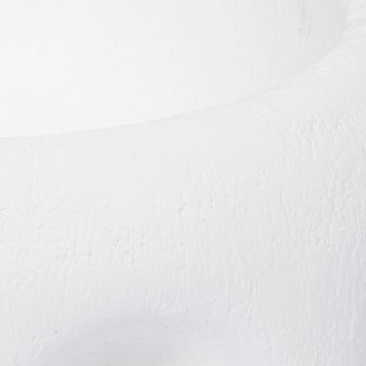 White gesso decorative bowl with textured finish, close-up of a curved surface