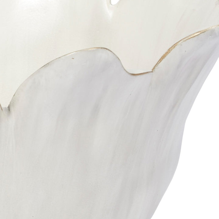 Cream decorative bowl close-up with ruffled rim shape and gold outline accents