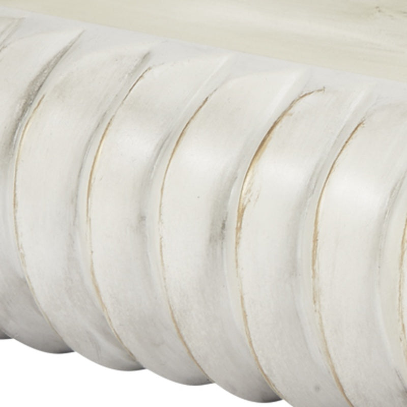 Cream oval bowl with carved ridges and thin gold accents, close-up texture