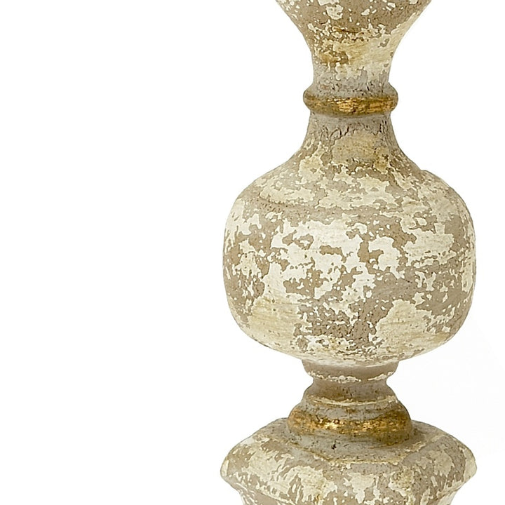 Gold-toned French-style candle stick with speckled white finish and fluted base