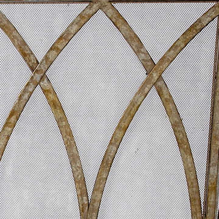 Champagne gold fireplace screen with diamond mesh and intersecting arched metal bars