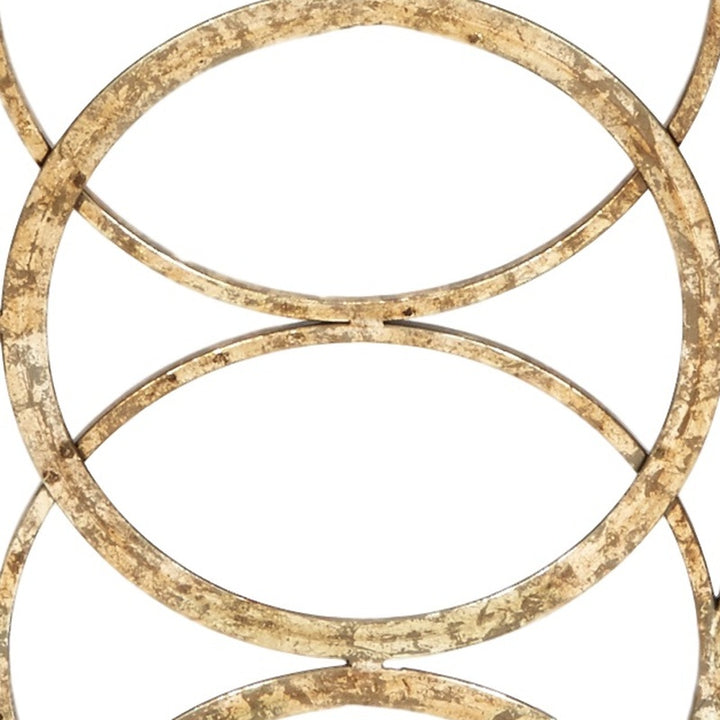Geometric fireplace screen detail of gold rounded rings