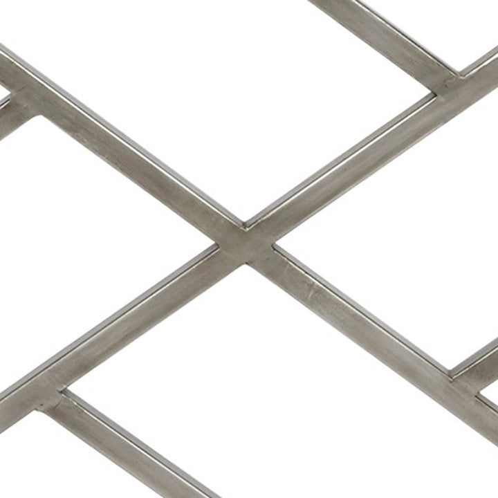 Silver metal fireplace screen close-up of X-cross bar and diamond grid sections
