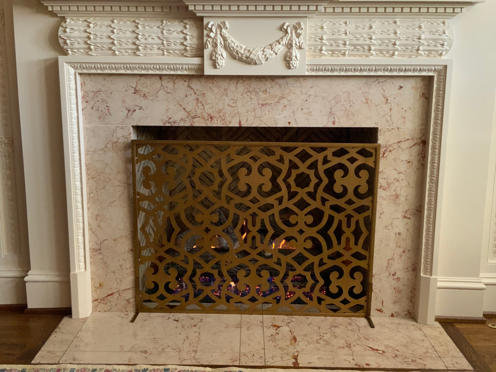 Chic Ramey fireplace screen in dark gold, offering a blend of modern elegance and timeless charm to protect your fire and enhance your space.