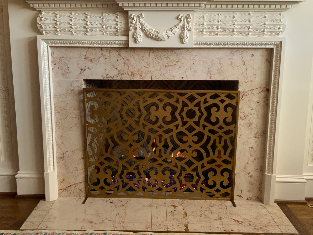 Chic Ramey fireplace screen in dark gold, offering a blend of modern elegance and timeless charm to protect your fire and enhance your space.
