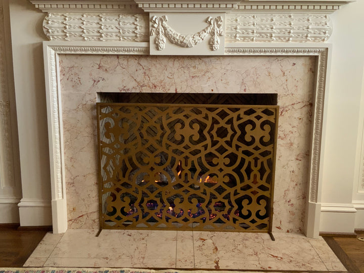 Chic Ramey fireplace screen in dark gold, offering a blend of modern elegance and timeless charm to protect your fire and enhance your space.
