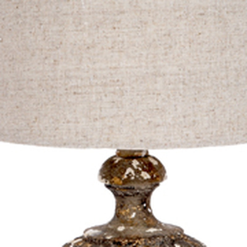 Gray linen lamp shade edge with aged gold glass base top
