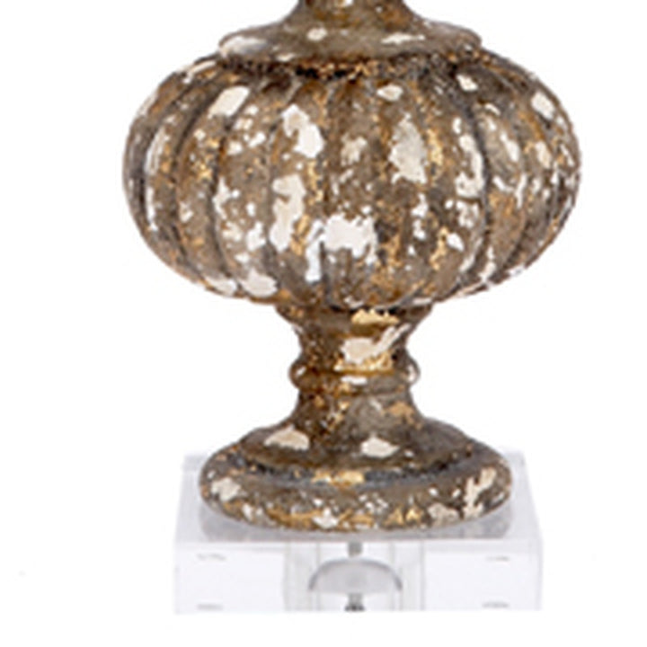 Aged gold glass lamp base with scalloped surface and finial