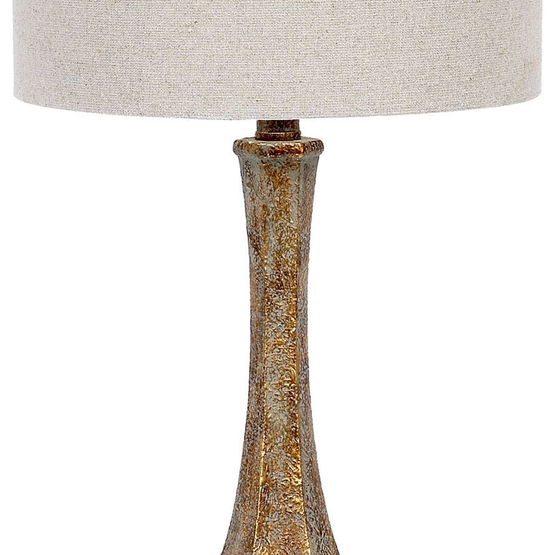 Beige linen drum shade with aged gold lucite lamp base
