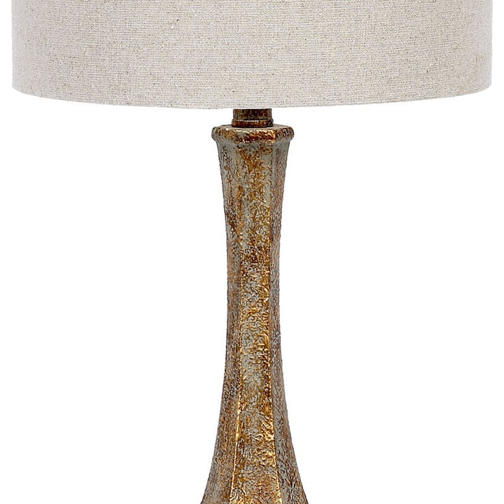 Beige linen drum shade with aged gold lucite lamp base