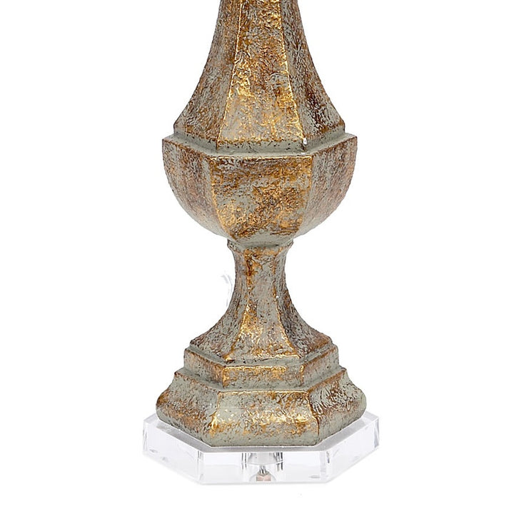 Aged gold lucite lamp base with finial and beige linen drum shade