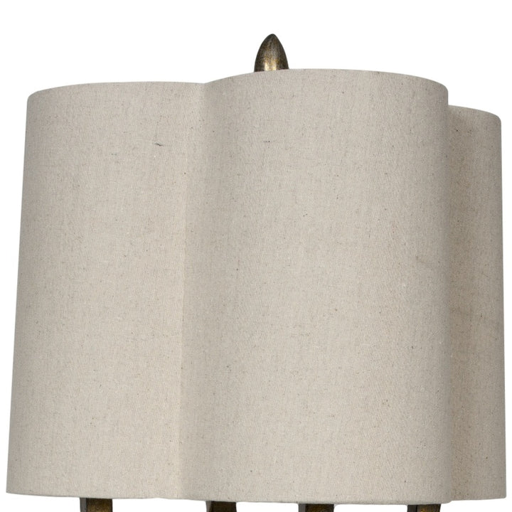 Fabric drum lamp shade in gray with finial tip, on quatrefoil lamp base
