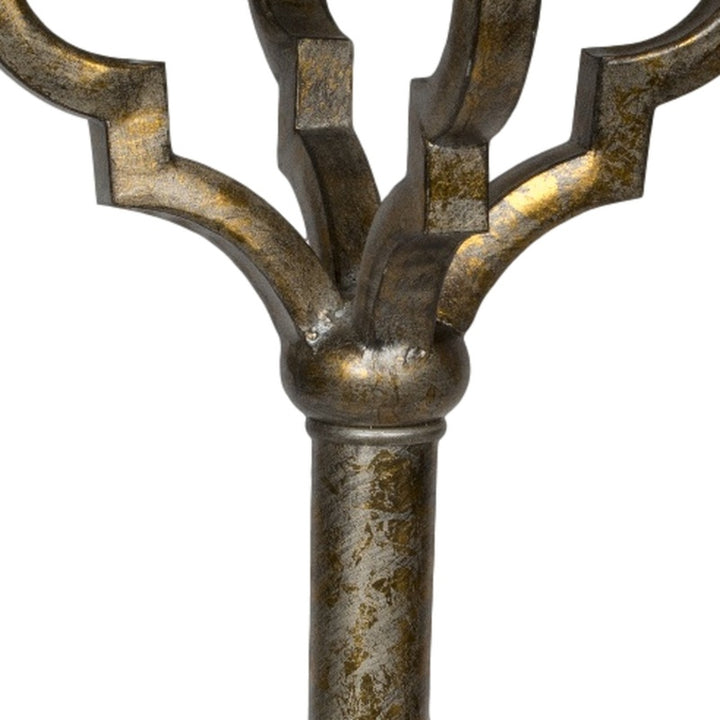 Close-up of quatrefoil lamp finial base in antique gold with curved arms