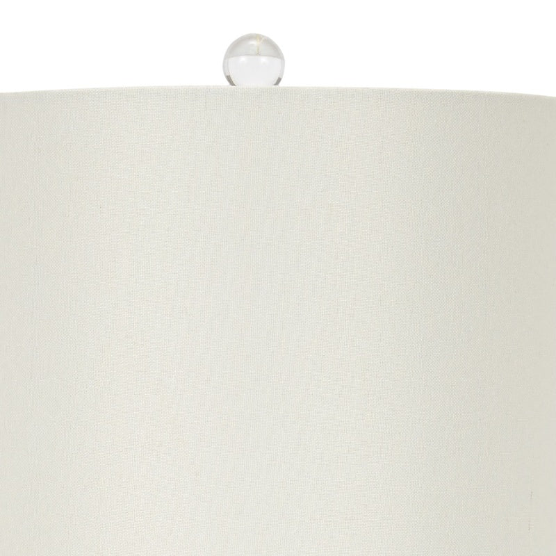 Table lamp with white fabric shade and glass finial accent