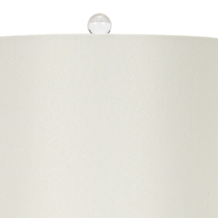 Table lamp with white fabric shade and glass finial accent