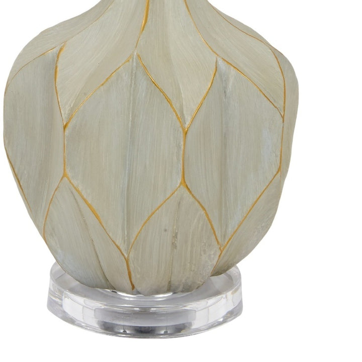 Table lamp with oval gray cement base and gold geometric line pattern
