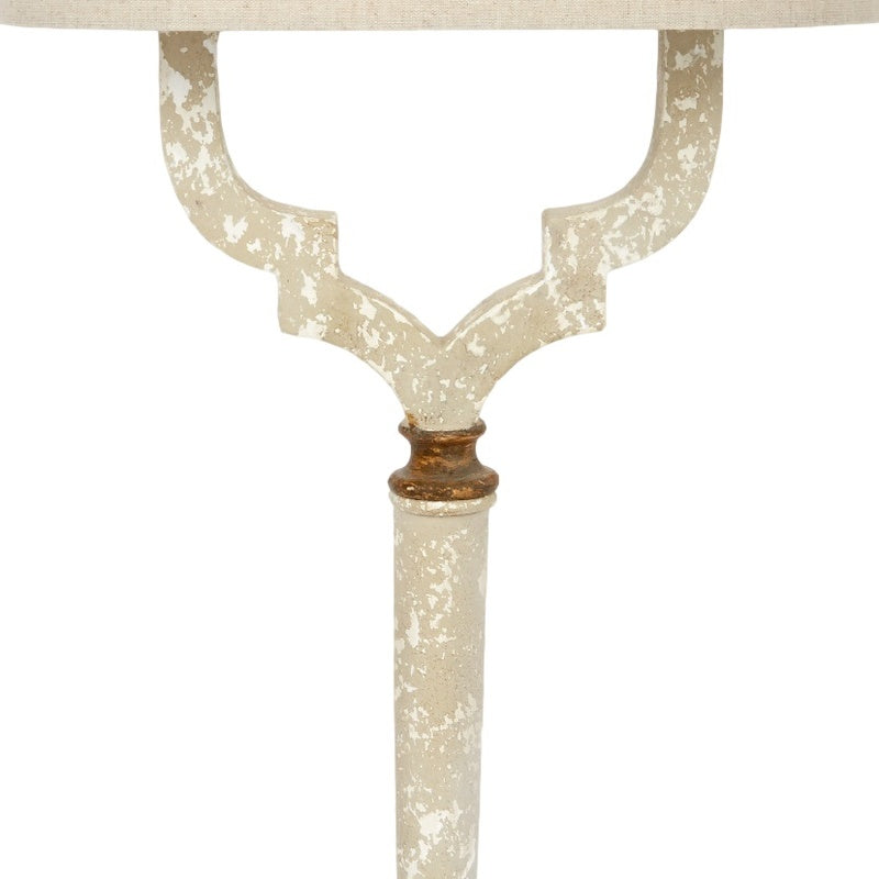 Distressed white lamp stem with gold-brown collar and ornate horn-style arms