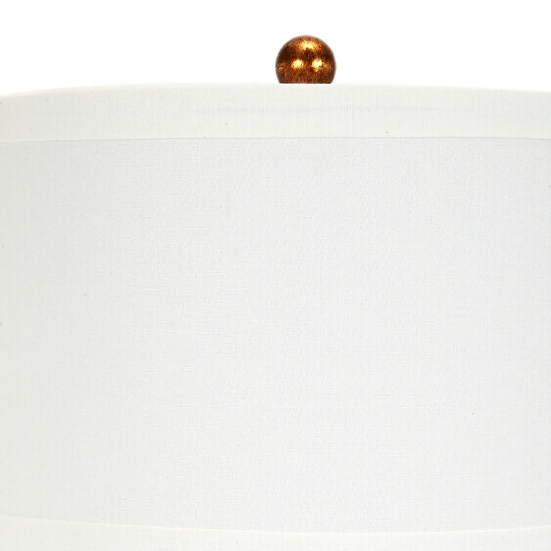 Hexagonal table lamp with white fabric shade and gold-toned finial