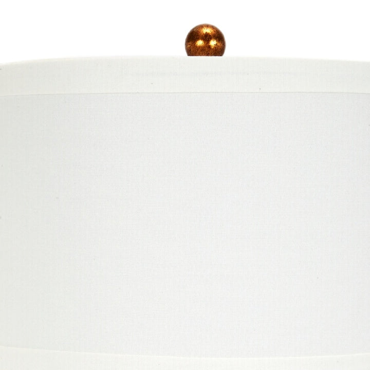 Hexagonal table lamp with white fabric shade and gold-toned finial